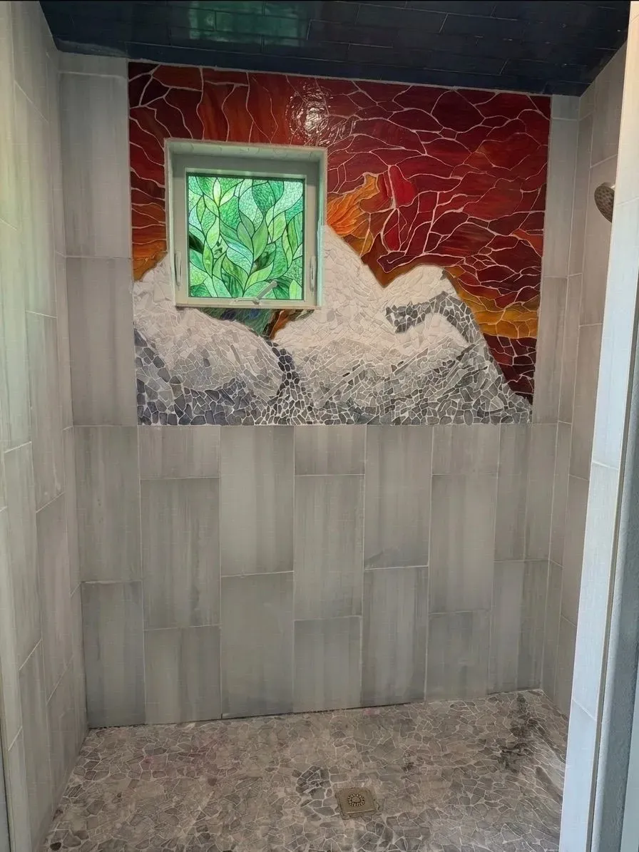 Hand-crafted Alpine Sunset mountain mosaic in a custom shower